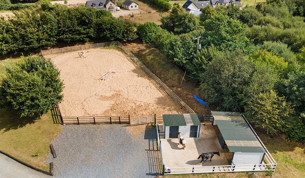 aerial view of stables and sand arena